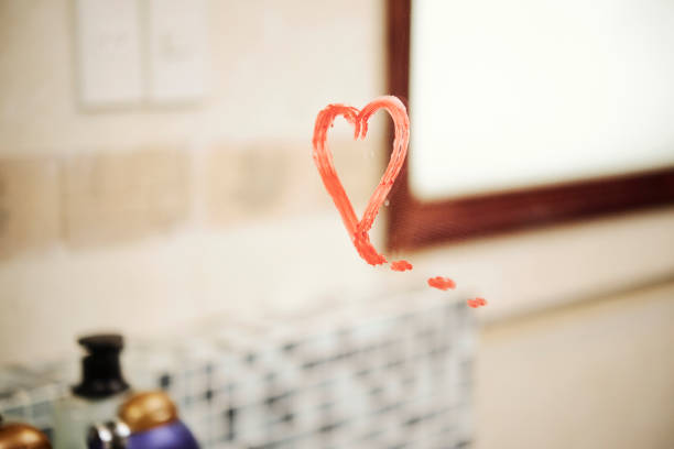Message on the mirror Heart shape drawing with red lipstick on the mirror in the bathroom mirror writing stock pictures, royalty-free photos & images
