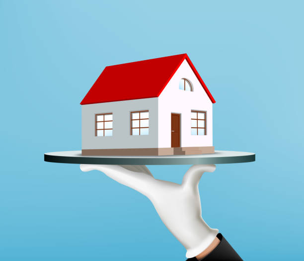 istock Waiter holds a tray with a house. Real estate agency 1151982010