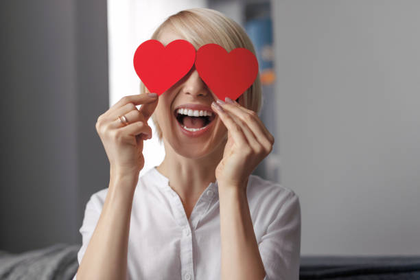 istock Laughing female with hearts near eyes 1151982061