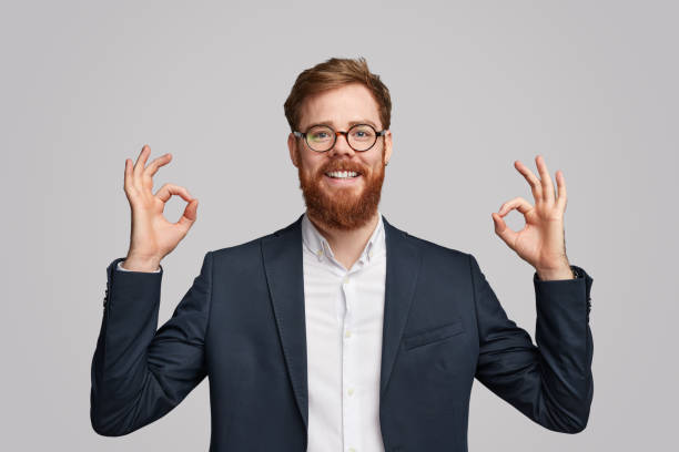 istock Smiling red bearded businessman gesturing OK 1151982123
