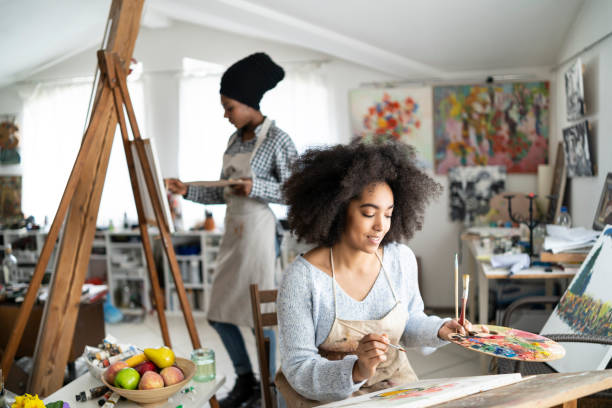 istock Female fine artists drawing in studio 1151982263