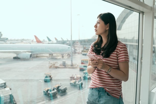 istock chinese woman watching plane before departure 1151982347