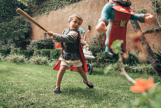 Boys breaking piñata at a party Boys breaking piñata at a party toddler hitting stock pictures, royalty-free photos & images