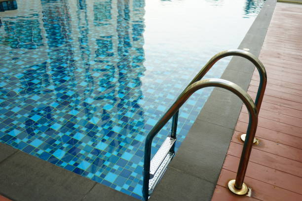 istock Swimming pool with grab bars ladder and stairs 1151985498