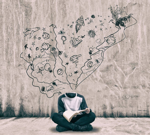 istock Headless man reading a book next to a painted wall. 1151987100