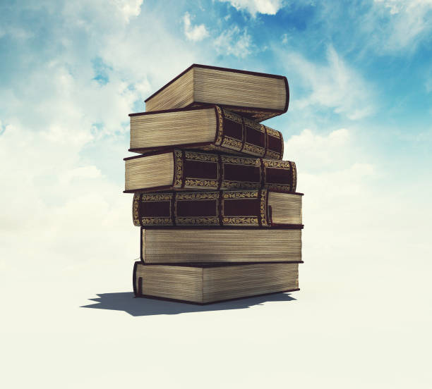 istock Tower of books on white background and cloudy sky. 1151987325