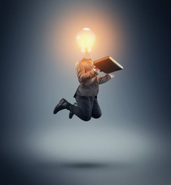 istock Businessman with a lit light bulb instead of head. 1151987530