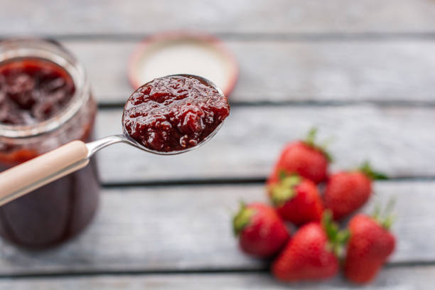 istock Spoon of strawberry jam, close-up. 1151987721