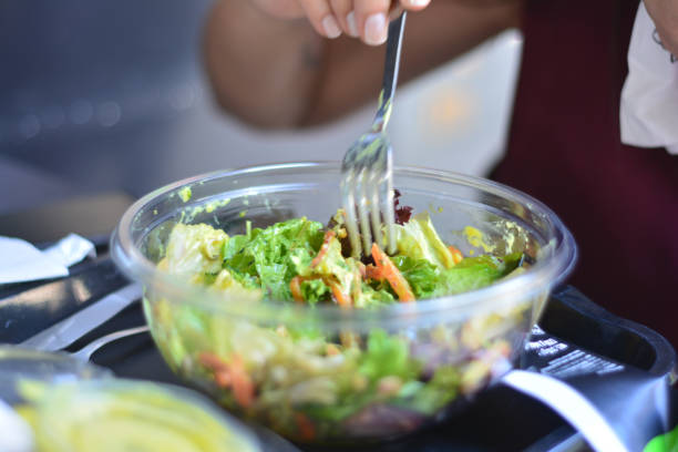 istock Young Woman Eating Salad 1151987857