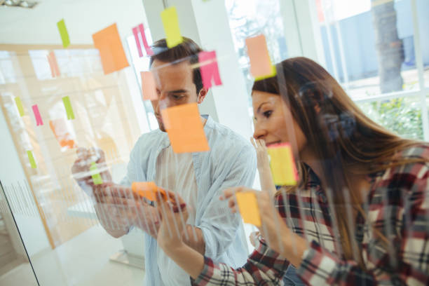 istock Young business people brainstorming on adhesive notes 1151989067