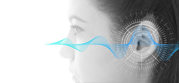 hearing test showing ear of young woman with sound waves simulation technology - tinitus imagens e fotografias de stock
