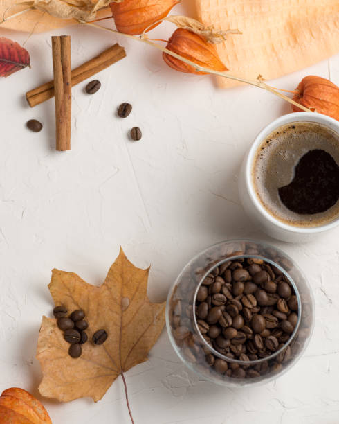 istock Autumn leaves and white Cup of coffee on white background 1151991721