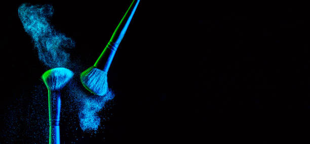 make up cosmetic brushes with powder blush explosion on black background. skin care or fashion concept. nice blue neon lighting. free space - face powder exploding make up dust imagens e fotografias de stock