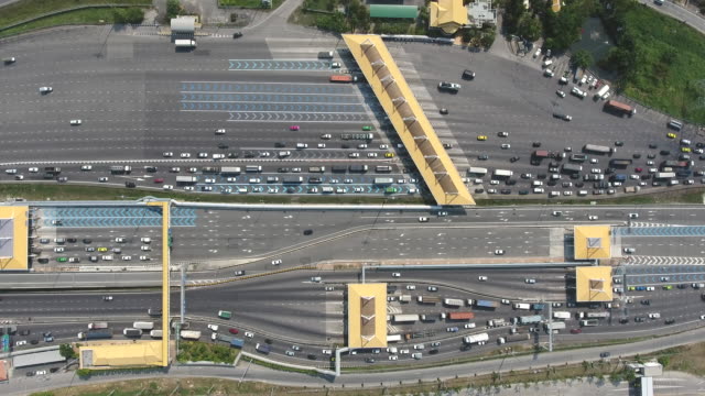 Aerial Top View Over Expressway Toll Gate with Many Vehicles Passing Through and Pay Fee