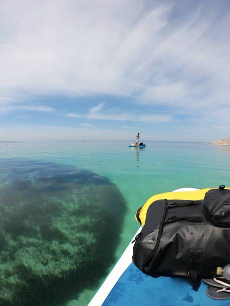 istock Man paddle boarding on transparent turquoise water 1151993142