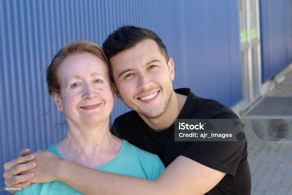 Woman in her sixties with man in his twenties Woman in her sixties with man in his twenties. Confidence Stock Photo