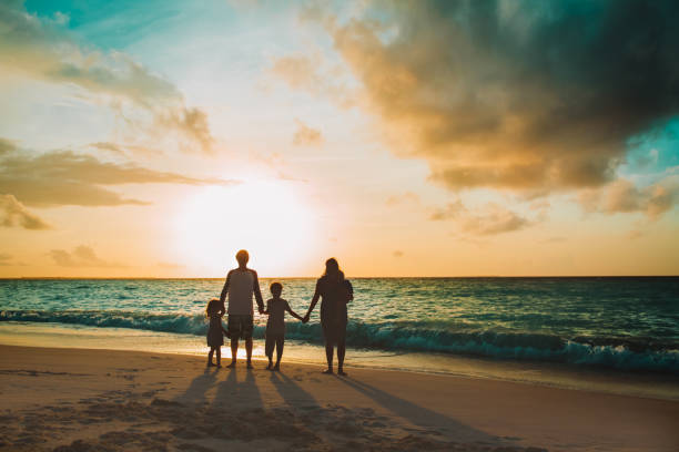 istock happy family with tree kids walk at sunset beach 1151994426