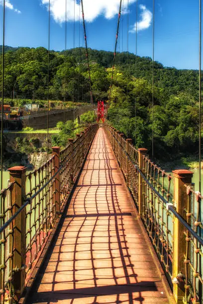 Beautiful red suspension bridge over Nanshi river, Wulai Village, New Taipei City, Taiwan