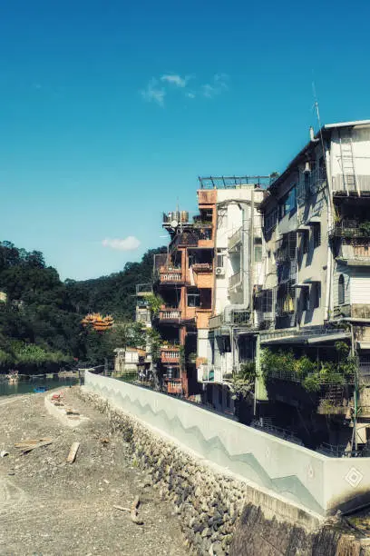 Old residential and business building built along side a river valley in Wulai, Taiwan