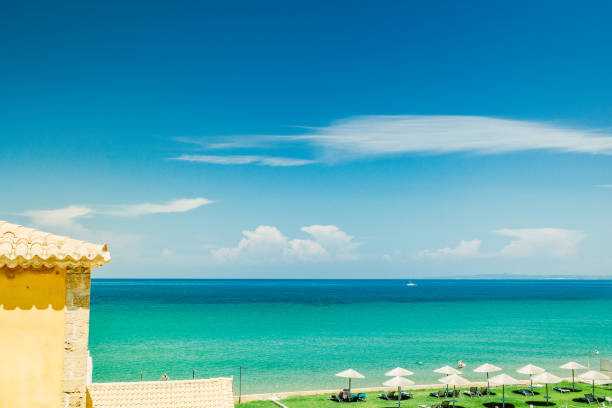 istock beach with parasol and turquoise sea 1151994804
