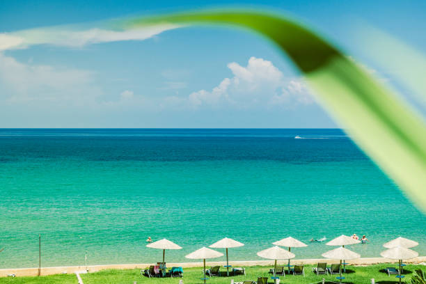 istock beach with parasol and turquoise sea 1151994904
