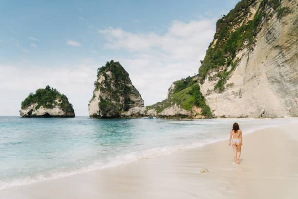 istock Woman walking on scenic beach on Nusa Penida 1151999430