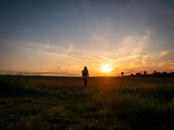 istock Young woman is going towards the sunset 1152000262