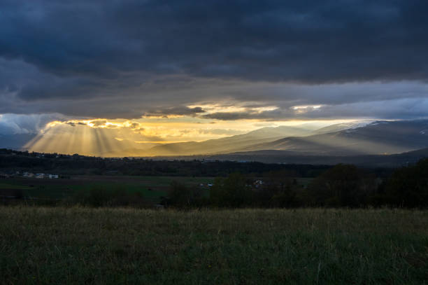 istock Sun rays beaming through the clouds and lighting up the valley 1152000470