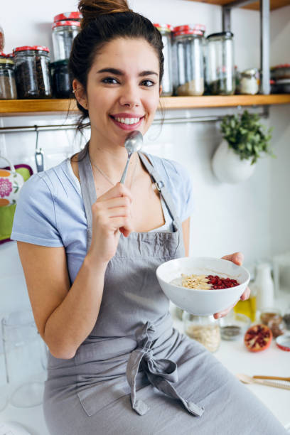 istock Beautiful young woman having breakfast in the kitchen. 1152000791