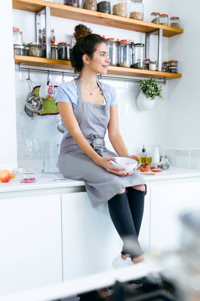 istock Beautiful young woman having breakfast in the kitchen. 1152000838