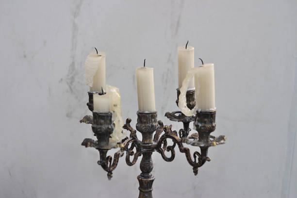 istock ancient candle holder with candle lights on the wall background 1152005954
