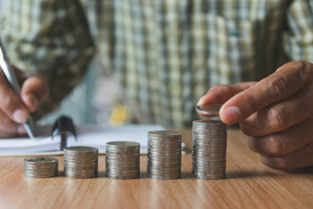 istock Men are Saint documents about save money  with  some coins on desk. 1152006044