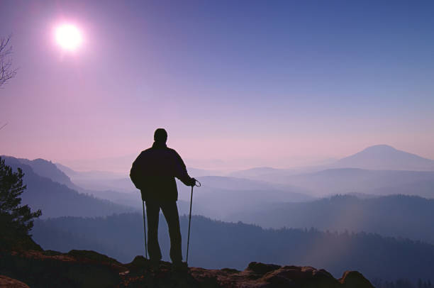 Climber with hiking backpack go to the mountains. Hikers in mountains. Male strong carrier with backpack and camping on hike in nature. Travel Concept