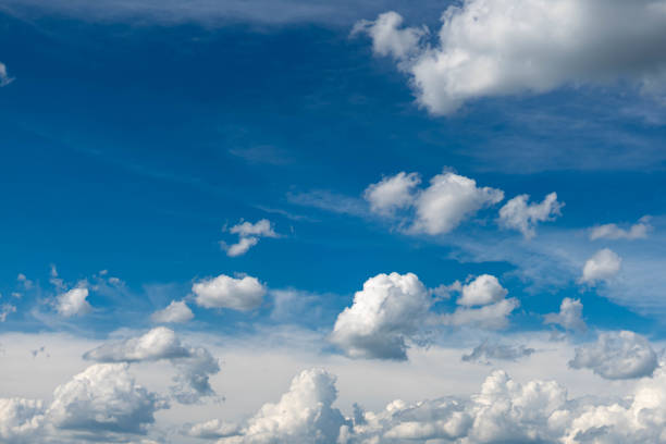 istock Beautiful blue sky with white clouds and a thin horizon line. Rays The sun breaks through the clouds. 1152007847