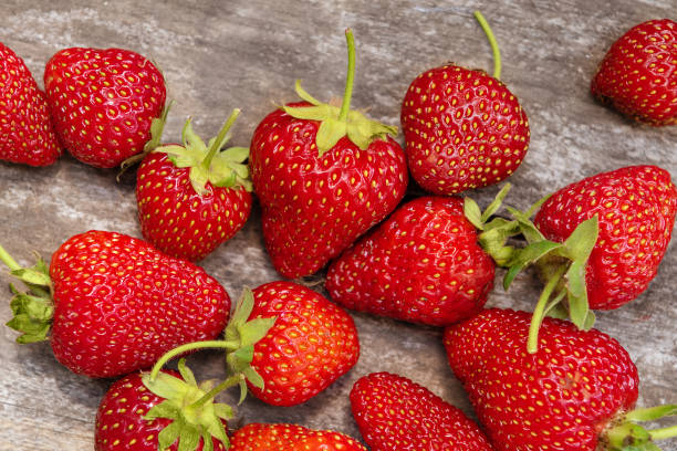 istock Fresh strawberry on wooden background, close up. 1152008345