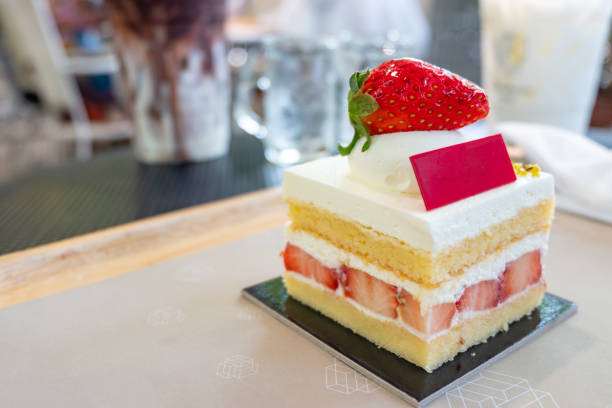 Close up slice of strawberry cake in cafe or restaurant