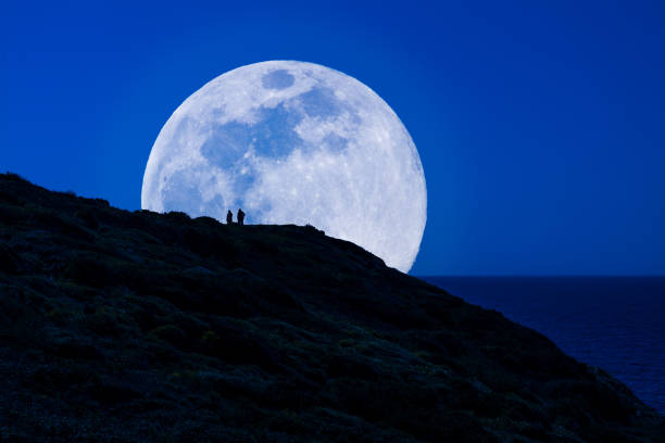 istock Silhouette of men under super moon 1152011482