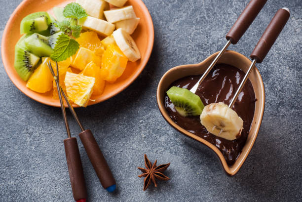 istock Chocolate fondue with fruit on a dark concrete background. concept summer party. Copy space 1152011721