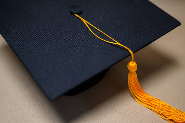 istock Black Graduation Hat placed on old books 1152011778