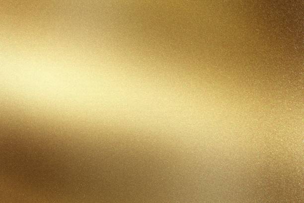 istock Glowing polished golden metal wall surface, abstract texture background 1152011800