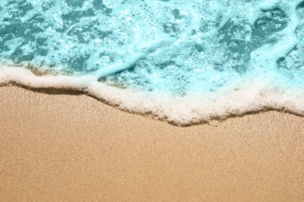 istock Soft wave of turquoise sea water on the sandy beach. 1152012063