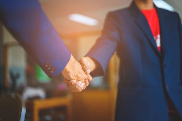 istock Two businessmen join hands for business cooperation. 1152012269