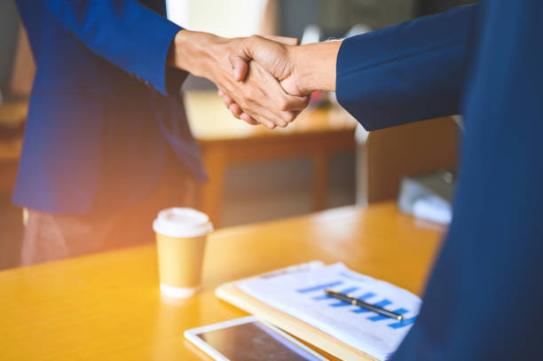 istock Two businessmen join hands for business cooperation. 1152012373
