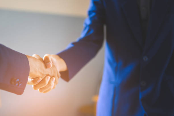 istock Two businessmen join hands for business cooperation. 1152012393
