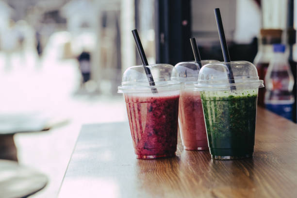 istock Sweet smoothie in plastic cups on wooden table 1152012415