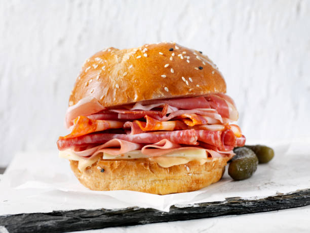 Italian Deli Sandwich on a Brioche Bun Italian Deli Sandwich on a Brioche Bun with Prosciutto, Salami, Chorizo Sausage, Cheese, Lettuce and Tomato cold cuts meat photos stock pictures, royalty-free photos & images