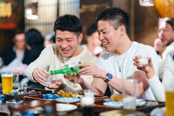 istock Man pouring alcohol to his friend’s cup 1152013642