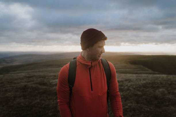 istock Hiker relaxes above meadow at sunrise 1152013933