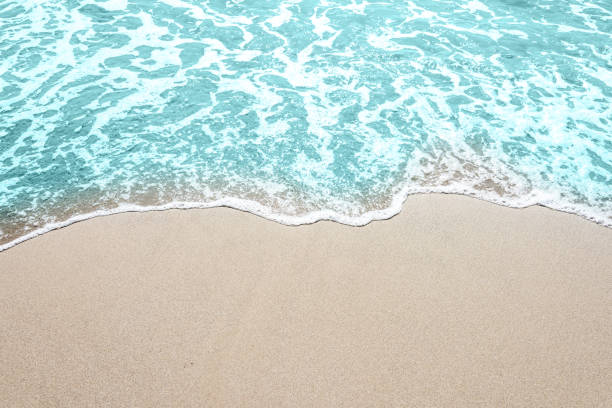 istock Soft wave of turquoise sea water on the sandy beach. 1152013936