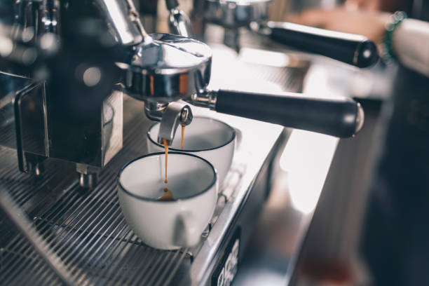 istock Drops of coffee falling into the cups on the coffee machine 1152014203